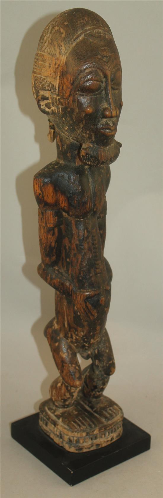 An African Ivory Coast Baule figure of a standing male, largest figure 20.5in.